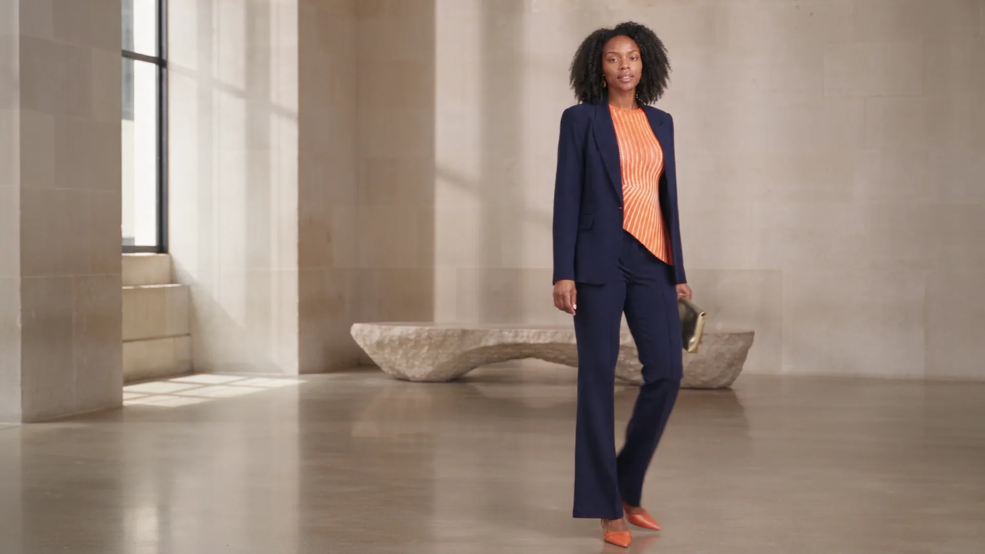 Amara wearing complementary navy and orange