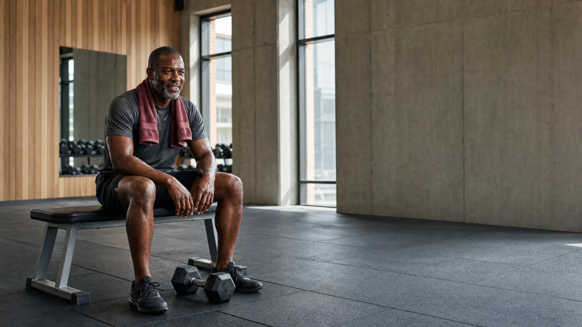 Marcus resting after training in a contemporary gym